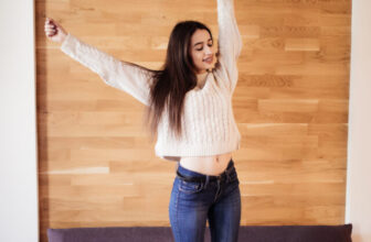 smiling happy lady work at home stretching arms to relax after hard day