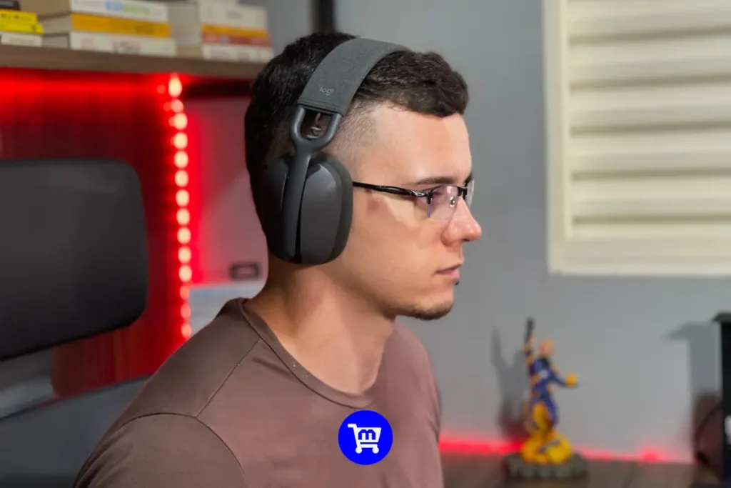 Logitech Zone Vibe 100 é bom? Análise Completa em 2025 2 Perfil lateral do Logitech Zone Vibe 100 sendo usado, mostrando o encaixe confortável mesmo com óculos e o design discreto do headset.