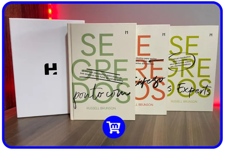 Trilogia Segredos H1 Editora - Box com os três livros de Russell Brunson (Segredos Ponto Com, Segredos do Tráfego e Segredos dos Experts) ao lado da caixa branca com logo da H1.